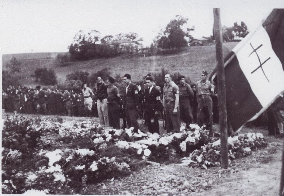 Des résistants se recuillent sur les lieux lors d'une cérémonie en Septembre 1944